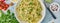 Banner with pesto pasta, bavette with walnuts, parsley, garlic, nuts, olive oil.Top view, long side, blue background