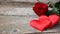 Banner. Red roses flowers with red hearts on old wooden background. Romantic Valentines holidays concept. Copy space. Top view