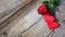 Banner. Red roses flowers with red hearts on old wooden background. Romantic Valentines holidays concept. Copy space. Top view