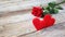 Banner. Red roses flowers with red hearts on old wooden background. Romantic Valentines holidays concept. Copy space. Top view