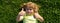 Banner with spring kids portrait. Funny child with thumbs up sign lying on grass, close up face. Kids enjoying summer