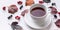 Banner: White Tea Mug, Leaves and berries. Autumn composition. Red foliage, ceramic teacup and small fruits on white background.