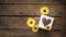 Banner of wood and yellow daisies with a heart motif to spell love with room for text