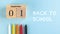 Banner with a wooden September 1 calendar, colored pens and back to school text on a blue background. Copy space