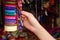 BANOS, ECUADOR, AUGUST, 17, 2018: Beautiful young woman in a shopstore looking for a woven bracelet, in a souvenirs area