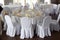 Banquet hall chairs, white tablecloth, food table, table setting, empty wine glasses, Banquet hall without people