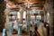 Banquet hall in the fortress style with vintage chandeliers, wooden ceiling, stone ornaments on the walls, columns, projector, TVs