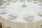 The banquet hall with round tables, with cutlery