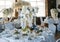 Banquet round tables, decorated with a bouquet of white flowers in the center of the tables