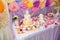 Baptism candy bar, angel statue, cupcakes, unfocused cake. Mastic cross on cake for christening child party.