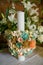 Baptismal candle with a round paper bouquet in an Orthodox church