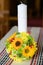 Baptismal candle with a sunflower bouquet in an Orthodox church