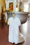 the baptismal shirt hangs on Baptismal font in the Orthodox Church.