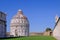 The baptistery at the Piazza Dei Miracoli with the famous Leaning Tower and the dome, Pisa, Tuscany, Italy