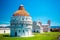 Baptistery of St. John on Square of Miracles, Leaning Tower, famous inclined tower of Pisa with green lawn in Pisa, Tuscany, Italy