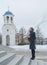 Baptized standing in front of the Orthodox Church a girl in a headscarf