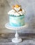 Baptizing blue cream cake with gingerbread cookies