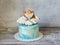 Baptizing blue cream cake with gingerbread cookies