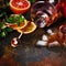 Bar accessories, drink tools and cocktail ingredients on rusty stone table. Flat lay style