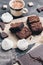 A bar of chocolate, meringue, pieces of chocolate cake and coffee. Selective focus
