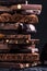 Bar of Chocolate tower pieces. Hazelnut and almond dark chunks of broken chocolate. Sweet food photo concept