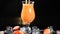 Bar and cocktail concept. Bartender prepare fruit Cocktails. Barman pours juice into glass with ice. Close up. Splashes