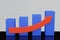 Bar graph in blue with an ascending arrow in red