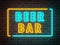 Bar neon light sign on dark night brick wall