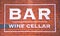 Bar sign on red brick with white frame