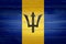 Barbados flag painted on old wood plank background. Brushed natural light knotted wooden board texture. Wooden texture background