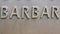 Barbar - inscription on the wall of metal letters
