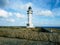 Barbaria Lighthouse at the top of a cliff