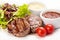 Barbecue Beef Steaks medium grilled with white and red sauces