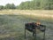 Barbecue with burning wood coals on the background of a river and forest