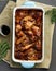 Barbecue chicken wings. Slow cooker sweet and spicy. Oven baked marinated chiken in blue ceramic tray, vertical