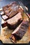 Barbecue chuck beef ribs with hot rub a sliced on a wooden cutting board