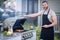 Barbecue concept. Middle aged hispanic man in apron for barbecue. Roasting and grilling food. Roasting meat outdoors