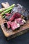 Barbecue dry aged wagyu bistecca alla fiorentina beef steak sliced with large filet piece with green asparagus and red wine salt