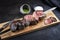 Barbecue dry aged wagyu Brazilian picanha from the sirloin cap of rump beef with chimichurri sauce on a skewer