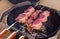 Barbecue dry aged wagyu picanha skewer preparing on an open fire kettle grill