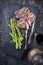 Barbecue dry aged wagyu porterhouse beef steaks with green asparagus on a charred wooden board