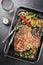Barbecue dry aged wagyu porterhouse steak with vegetable, chili and onions in a skillet
