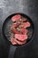 Barbecue dry aged wagyu sirloin beef steak sliced with salt and pepper on a gray cast iron design pan