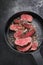 Barbecue dry aged wagyu sirloin beef steak sliced with salt and pepper on a modern design pan