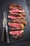 Barbecue dry aged wagyu tagliata di manzo entrecote beef steak on a black rustic slate