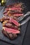 Barbecue dry aged wagyu tagliata di manzo entrecote beef steak on a rustic black slate