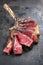 Barbecue dry aged Wagyu Tomahawk Steak sliced and offered on old metal sheet
