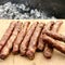 Barbecue with fiery Bavarian sausages on grill in garden outdoors