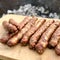 Barbecue with fiery Bavarian sausages on grill in garden outdoors