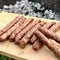 Barbecue with fiery Bavarian sausages on grill in garden outdoors